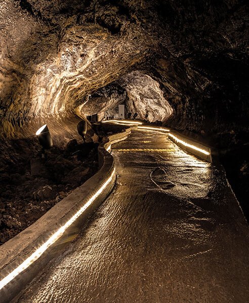 Dark passageway with lighting running along the edges of the path.