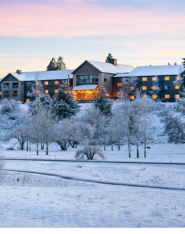 Aerial view of the resort in the winter with snow covering the ground and surrounding area.