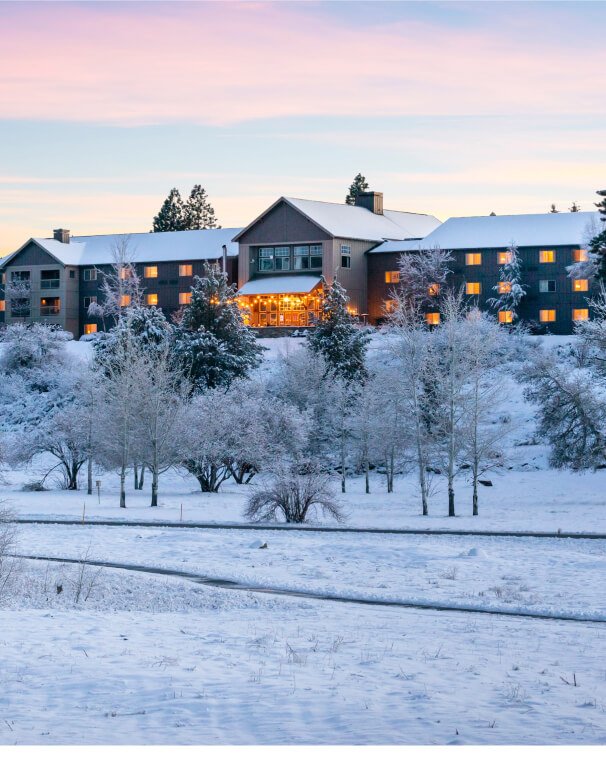 Aerial view of the resort in the winter with snow covering the ground and surrounding area.