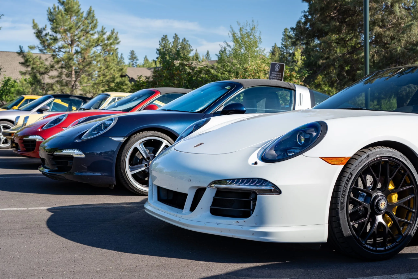 A lineup of luxury cars outside.