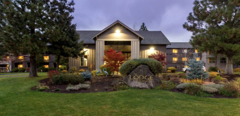 A view of the exterior of The Lodge at dusk.