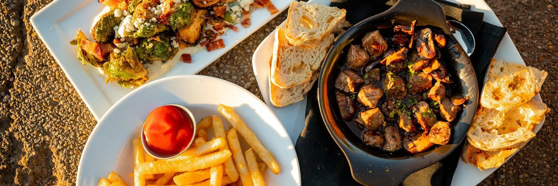 A top down view of various plates of food.