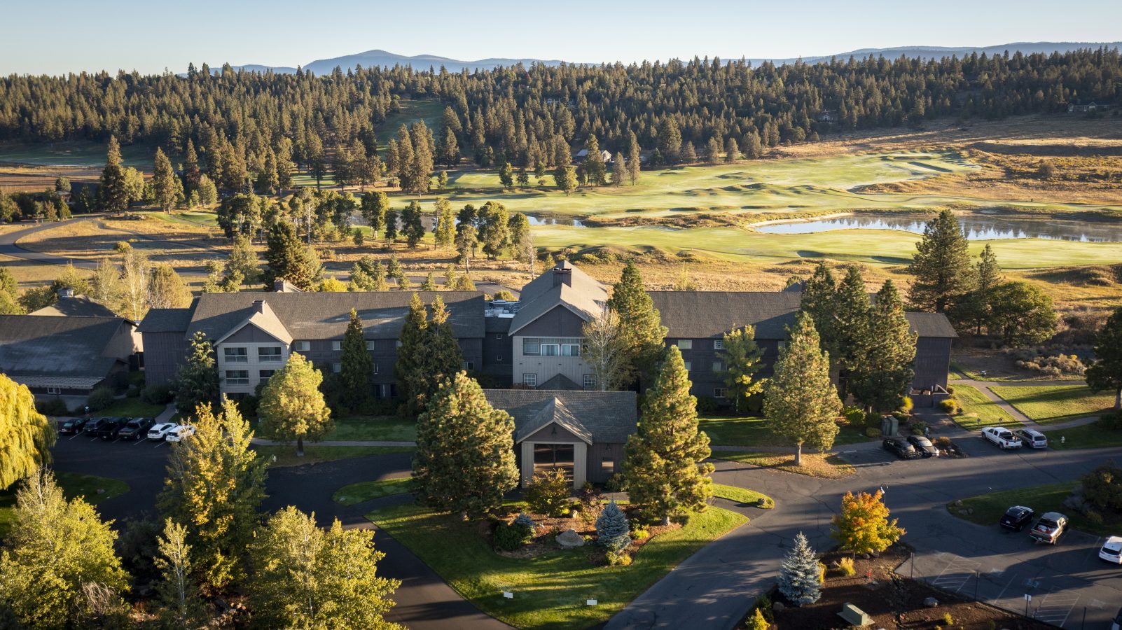 Aerial view of Running Y Resort Lodge with Arnold Palmer Golf Course spreading out behind.
